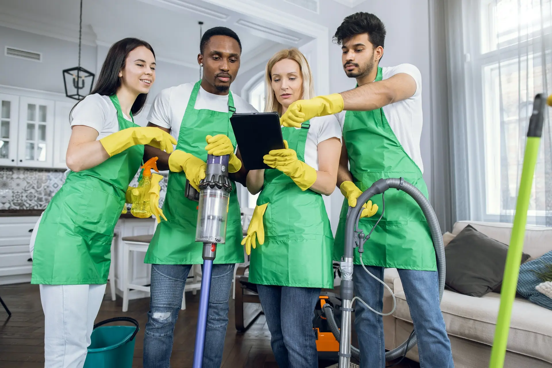 professional focused multiethnic cleaning team discussing joint work in customer flat